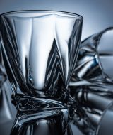 close up of cognac glasses on grey with reflections