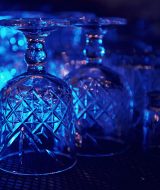 Close up view of row of empty glasses on table in the pub indoors.